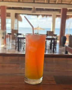 a drink sitting on top of a wooden table at Coconut Resort in Tuléar +27 photos