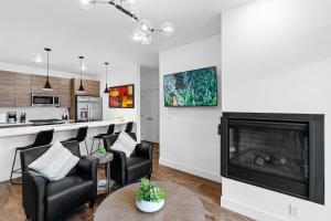 a living room with a fireplace and a kitchen at Apres Shores #C13 in Silverthorne