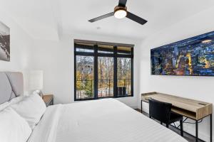 a bedroom with a bed and a desk and a ceiling fan at Apres Shores #C13 in Silverthorne