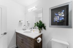 a bathroom with a sink and a mirror and a toilet at Apres Shores #C13 in Silverthorne +28 photos