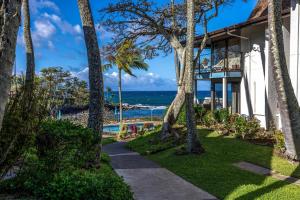 a house with a view of the ocean at Spacious 2BR Oceanfront Loft - Unit C17 condo in Lahaina