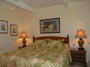 a bedroom with a bed and two lamps on tables at Peaceful Ocean-View 2BR Loft Escape - Unit C38 condo in Lahaina