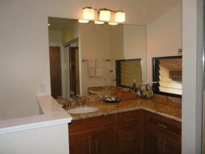 a bathroom with a sink and a large mirror at Peaceful Ocean-View 2BR Loft Escape - Unit C38 condo in Lahaina +8 photos