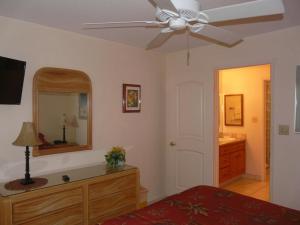 a bedroom with a bed and a ceiling fan at Napili Point Oceanfront Turtle View 1BR - Unit B30 condo in Lahaina