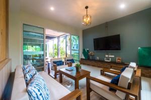 a living room with a couch and a tv at Siya Private Pool Villa Ao Nang in Ao Nang Beach