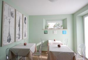 a dining room with two tables with white table cloth at B&B Incanto sotto il mare in San Benedetto del Tronto
