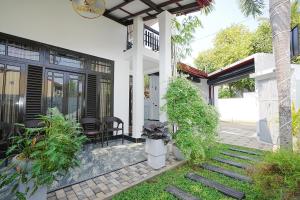 a porch of a house with plants on it at lumiere south Residence in Matara