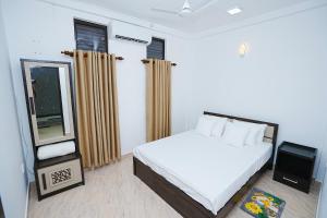 a bedroom with a white bed and a television at lumiere south Residence in Matara +33 photos