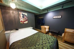 a hotel room with a bed and a chair at Hotel Mju-Adult Only in Tokyo +19 photos