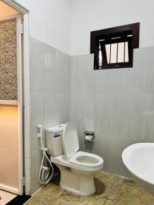 a bathroom with a toilet and a sink at KOKO Villa in Kochchikade