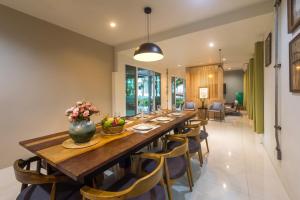 a long dining room with a long table and chairs at Siya Private Pool Villa Ao Nang in Ao Nang Beach