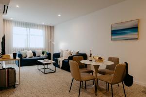 a living room with a couch and a table at Punthill Williamstown in Williamstown