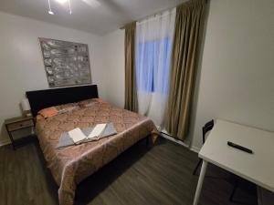 a bedroom with a bed with two books on it at Brossard home2 in Brossard +14 photos