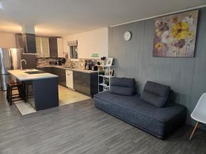 a living room with a couch and a kitchen at Brossard home2 in Brossard