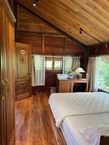 a bedroom with a bed and a wooden ceiling at Moc Homestay & Villa in Cư Chinh +32 photos