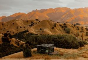 a small cabin on the side of a mountain at Manakau PurePod in Kaikoura +7 photos