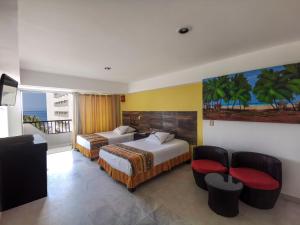 a hotel room with two beds and a balcony at Condominios Torre Continental Ixtapa in Ixtapa +98 photos