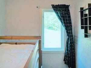 a bedroom with a bed and a window at Comfortable Apartment Near Stenungsund in Munkedal