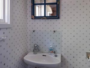 a bathroom with a sink and a mirror at Comfortable Apartment Near Stenungsund in Munkedal