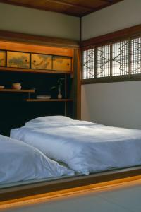 a bedroom with a large bed with blue sheets at 帰々Kiki in Yamatokoriyama