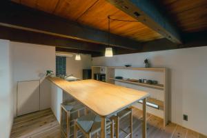 a kitchen with a wooden table in a room at 帰々Kiki in Yamatokoriyama