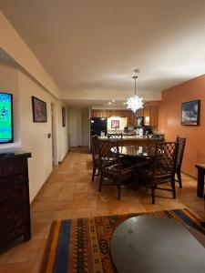 a dining room and living room with a dining table at La Paloma in Rosarito Beach