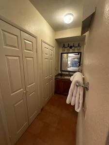 a hallway with a door with a towel hanging on it at La Paloma in Rosarito Beach +10 photos