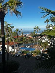 a view of a resort with a pool and palm trees at La Paloma in Rosarito Beach