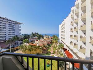 a balcony with a view of the ocean and buildings at Condominios Torre Continental Ixtapa in Ixtapa
