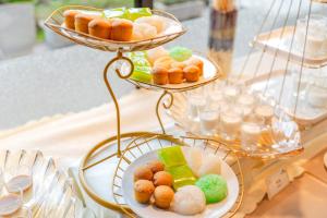 a table with three plates of pastries on a table at Nice Dream Hotel in Da Lat