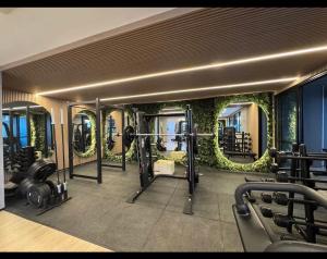 a fitness room with a gym with plants on the walls at Azure Aesse Hospitality Marista in Goiânia