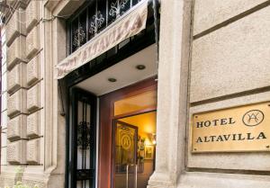 a hotel entrance with a sign on a building at Hotel Altavilla 9 in Rome