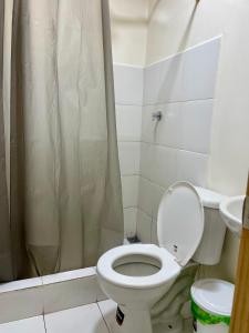 a bathroom with a toilet and a shower curtain at Mini Suites Cuarto Piso Alkimya in Loja +35 photos