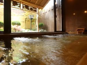 a large pool of water in a room with a koi at Shoji Mount Hotel - Vacation STAY 83000v in Narusawa +17 photos