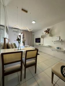 a dining room with a table and two chairs and a room at Flat JK 203 in Juazeiro do Norte