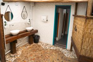 a bathroom with two sinks and a mirror at Clan.Destino Hostel in Ilhabela +30 photos