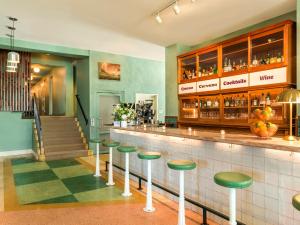 a bar in a restaurant with green stools at Hotel Trouvail Miami Beach in Miami Beach