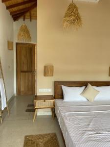 a bedroom with two beds and two baskets on the wall at Dreamers Surf House in Matara