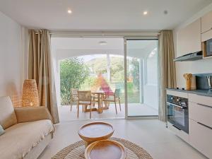 a living room with a couch and a table at Suite studio à Anse Marcel - 2 pers. - FR-1-734-87 in Marigot