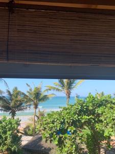 a view of the beach from a train window at Dreamers Surf House in Matara