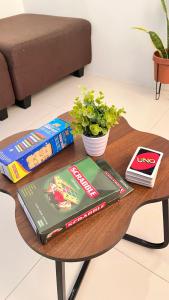 a table with books on it with a table at The HappyNest Tagum in Tagum
