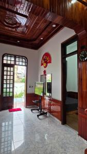 a living room with a computer in the center of a room at Rose House - Quảng Bình in Bố Trạch