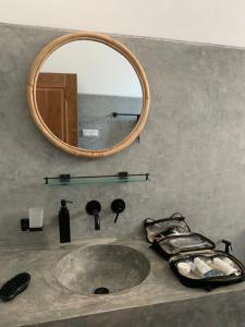 a bathroom sink with a mirror on a counter at Dreamers Surf House in Matara +104 photos