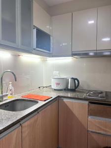 a kitchen with a sink and a counter top at Mactan Newtown Studio Type with Balcony in Punta Engaño