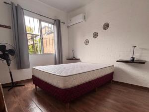 a bed in a room with a large mattress at Complejo San Luis in San Luis +13 photos