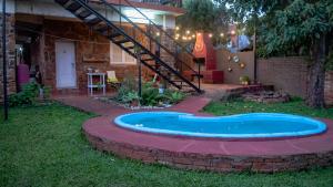 a pool in the yard of a house with a staircase at Residencial Villalobos in Eldorado
