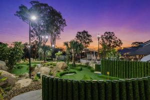 a golf course in a park with a fence at Alexandra Hills Hotel in Cleveland