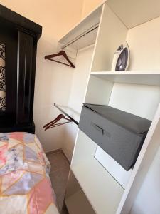a bedroom with white shelves and a bed at Private Loft Free Parking Pet friendly in Chapulco