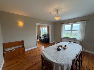 a living room with a table and a couch at Trá Leathan in Doolin
