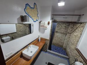 a small bathroom with a sink and a shower at Apo Diver Beach Resort in San Juan +63 photos